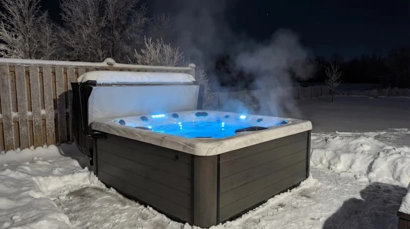 Hot tub covered with snow in Ontario winter backyard
