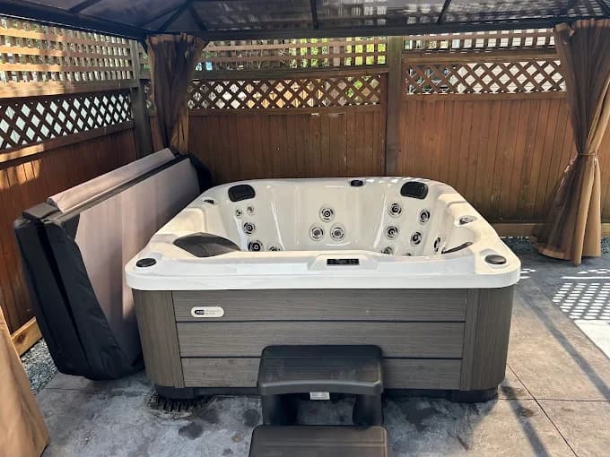 Hot tub under gazebo with cover lifter