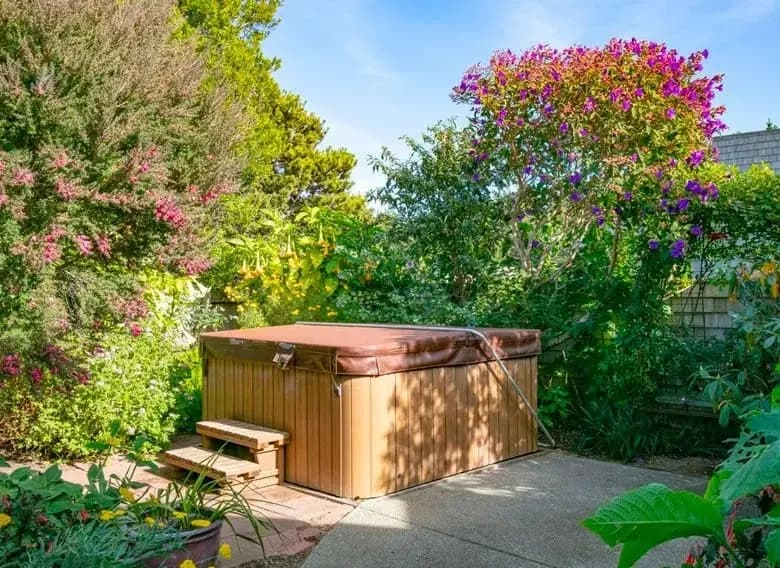 Hot tub in lush garden setting