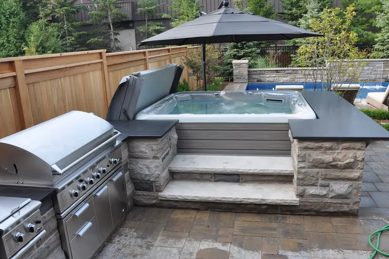 Built-in hot tub with outdoor kitchen