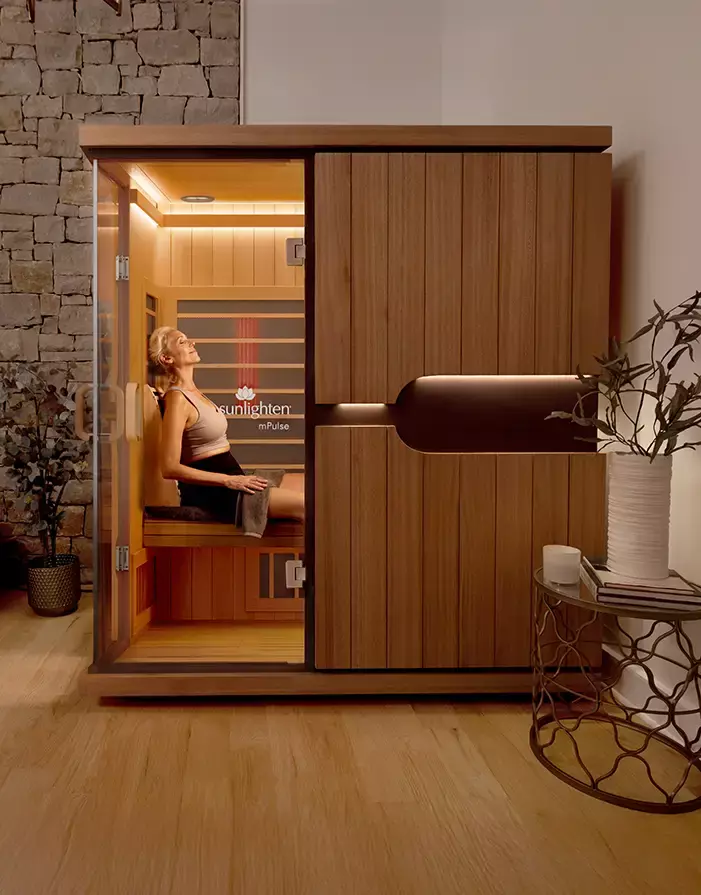 Sunlighten Amplify cabin glowing through its eight chromotherapy colours