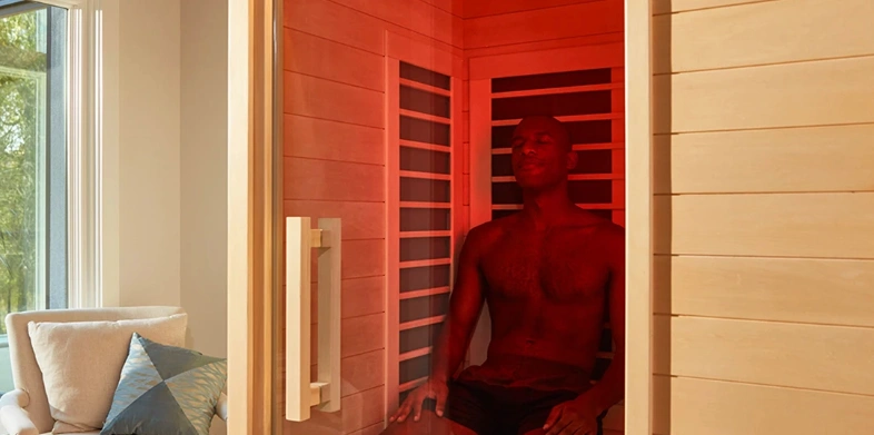 Sunlighten Signature cabin glowing through its eight chromotherapy colours